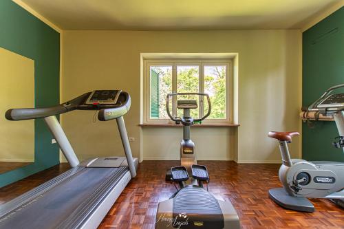 a gym with two exercise bikes in a room at Villa Fiori B&B in Moncalvo