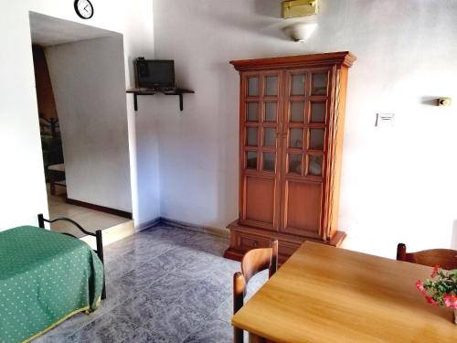 a dining room with a wooden cabinet and a table at Holiday Residence in Casamassima