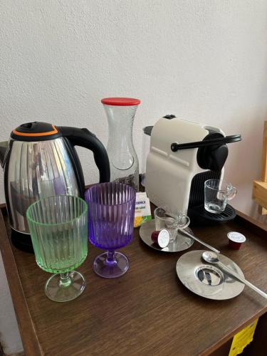a table with glasses and a coffee maker on it at La Conchita Tulum in Tulum