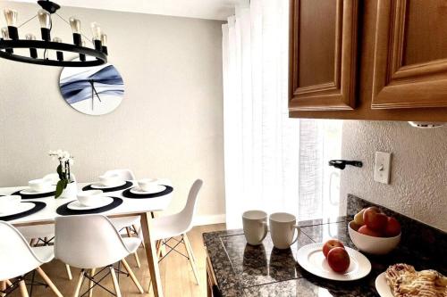a kitchen with a table with chairs and a dining room at Bright Home - Huge Backyard 20 min - Denver & Boulder in Broomfield
