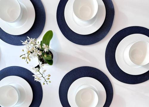 a table with black and white plates and a vase at Bright Home - Huge Backyard 20 min - Denver & Boulder in Broomfield