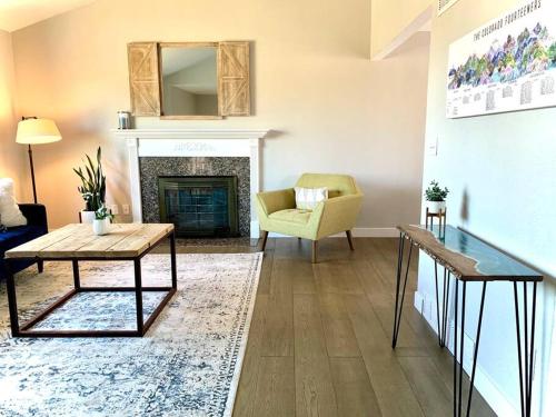 a living room with a table and a fireplace at Bright Home - Huge Backyard 20 min - Denver & Boulder in Broomfield
