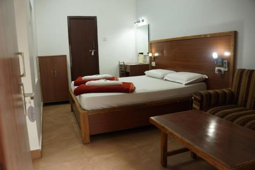 a hotel room with a bed and a table at Subhash Hotel in Prayagraj