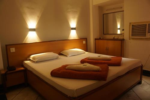 a bedroom with a bed with two towels on it at Subhash Hotel in Prayagraj