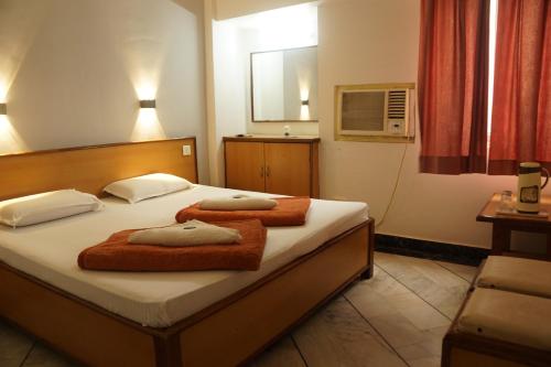 a bedroom with two beds with towels on them at Subhash Hotel in Prayagraj
