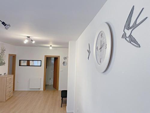 a clock on a wall in a room at Apartman Danijela in Popovača