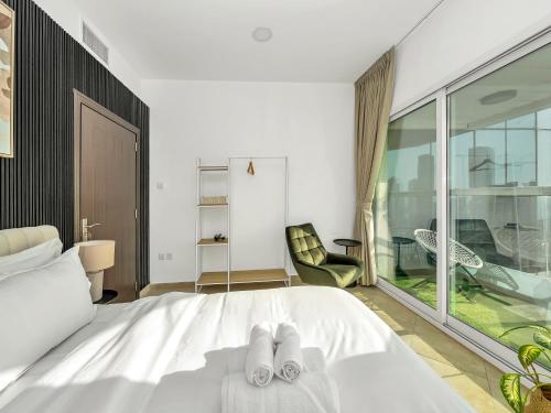 a bedroom with a bed with two slippers on it at Stunning Panoramic Sea & Marina Skyline View in Dubai
