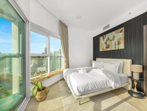 a bedroom with a bed and a large window at Stunning Panoramic Sea & Marina Skyline View in Dubai