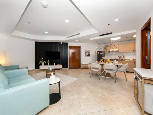 a living room with a couch and a table at Stunning Panoramic Sea & Marina Skyline View in Dubai