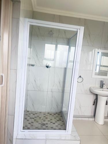 a shower with a glass door in a bathroom at Montrose BnB in Margate