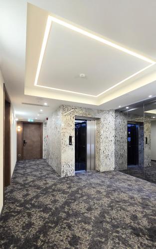 a large room with a large ceiling with tiles at Griffin Hotel in Tbilisi City