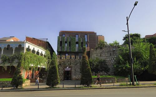 an old building with people walking on a street at Griffin Hotel in Tbilisi City