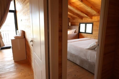 a bedroom with a bed in a wooden house at Posh villa 1 in Kavajë