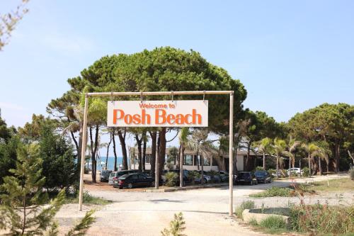 a sign for a pool beach on a street at Posh villa 1 in Kavajë
