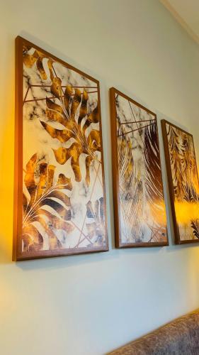 four framed pictures on a wall with a painting at Villa michlo in El Makina