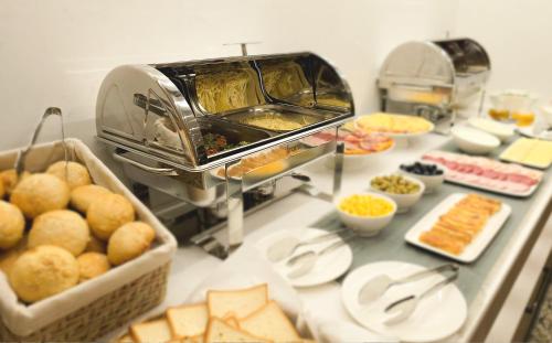 a buffet line with food on a counter with food at Griffin Hotel in Tbilisi City