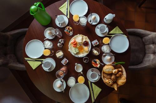 a table with plates and cups and food on it at Das Arni´s in Mehlmeisel