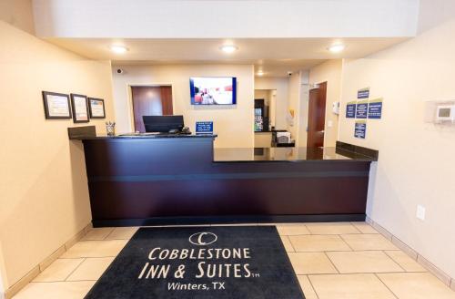 a lobby of a hospital with a reception desk at Cobblestone Inn & Suites - Winters in Winters