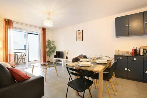 une cuisine et un salon avec une table et des chaises dans l'établissement NEW-Le Patio St Cyprien - Parking - Terrasse - Netflix, à Toulouse