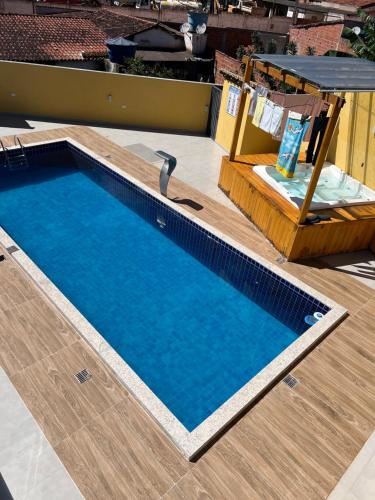 a small swimming pool on a deck with a chair next to it at Casa Diamantina in Ibicoara