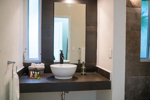 a bathroom with a sink and a large mirror at 3BR Casa Matuk I Steps from Spectacular Beach I Private Pool in Playa del Carmen