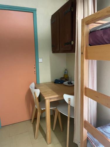 a room with a table and chairs and a bunk bed at chambre 4 personnes avec entrée indépendante , grand parking, salle de bain, wc in Confolens