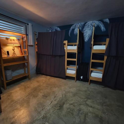 a room with two bunk beds and a window at Casa Coral in Luquillo