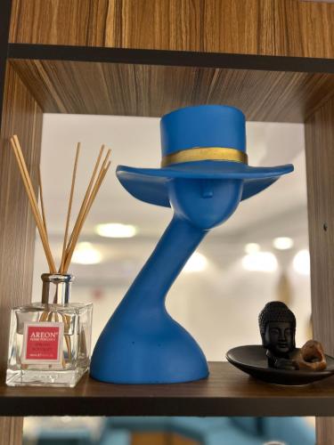 a blue hat sitting on top of a shelf at Celestia Boutique Inn - Boutique Stay Overlooking Jerash Ruins in Jerash