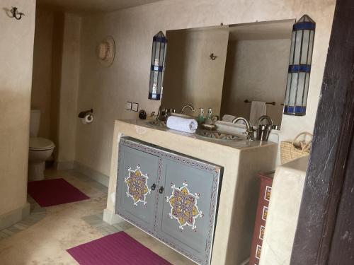a bathroom with a sink and a mirror at Riad Syba in Marrakech