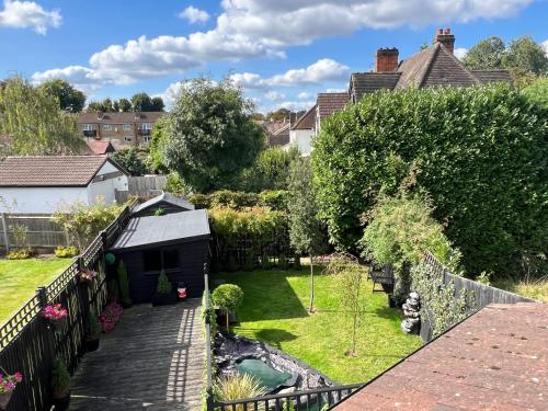a view of a garden from the balcony of a house at Beddington Park Lodge East in Wallington