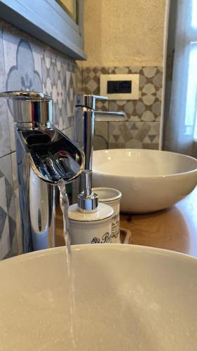 a kitchen counter with water coming out of a sink at Casa Pinocchio appartamento esperienziale in San Giorgio Canavese