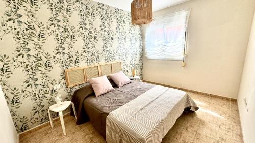 a small bedroom with a bed and a window at Bohemian Dreams Los Abrigos by Deihu Experiences in Granadilla de Abona