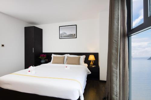 Ένα ή περισσότερα κρεβάτια σε δωμάτιο στο Meriton Hotel Nha Trang