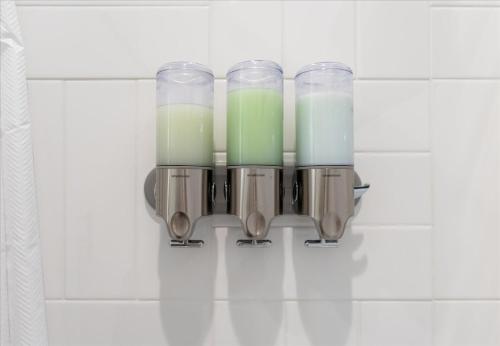 a group of candles hanging on a wall in a bathroom at New Lake Retreat Sleep 17 Poolspagameroomview in Granite Shoals