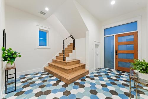 a staircase in a house with a checkered floor at New Lake Retreat Sleep 17 Poolspagameroomview in Granite Shoals