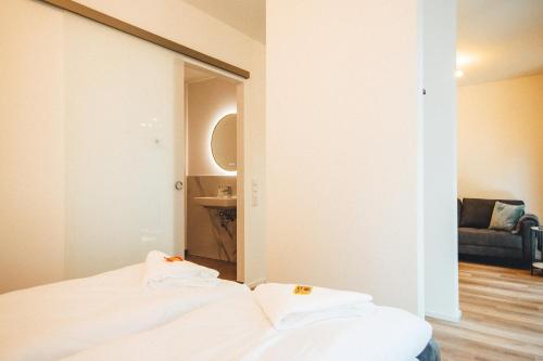 Ένα ή περισσότερα κρεβάτια σε δωμάτιο στο THE WOS Apartments
