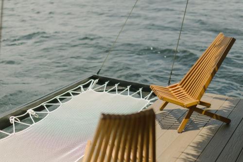 two chairs sitting on the deck of a boat at Premium Floating Bungalow by Stay Ombi in Key Largo