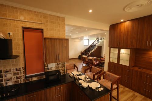 a kitchen with a table and chairs in a room at Vista Valley Stay, Luxury 3 BHK Villa Kangra, Dharamshala in Dharamshala