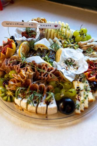 a platter of different types of food on a plate at Almond Blossom Cottage 2 in Philotium