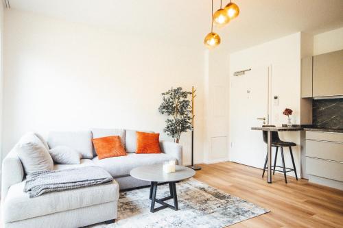 a living room with a couch and a table at THE WOS Apartments in Mönchengladbach