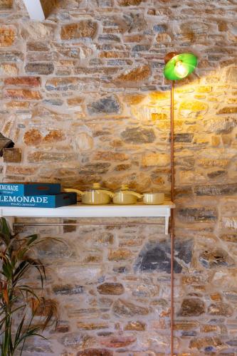 a lamp sitting on a shelf next to a brick wall at Almond Blossom Cottage 2 in Philotium