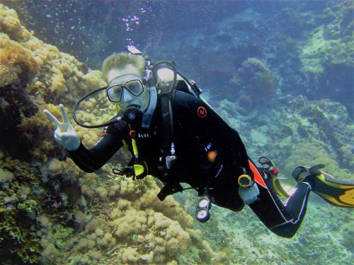 a man in a diving suit giving the peace sign at Bohol South Beach Hotel in Panglao