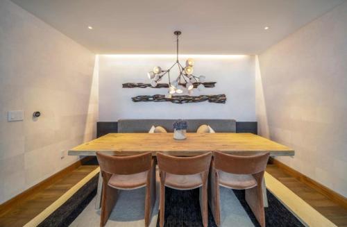 a dining room with a wooden table and chairs at One Snowmass West 501 by Snowmass Mountain Lodging in Snowmass