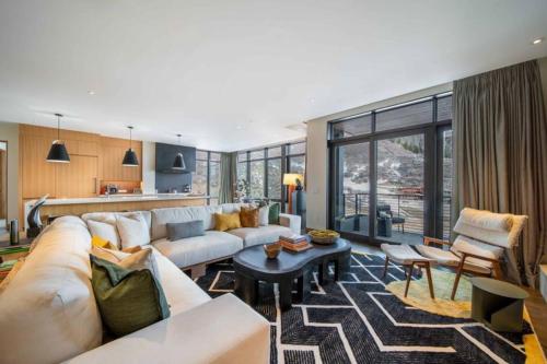 a living room with a couch and a table at One Snowmass West 501 by Snowmass Mountain Lodging in Snowmass