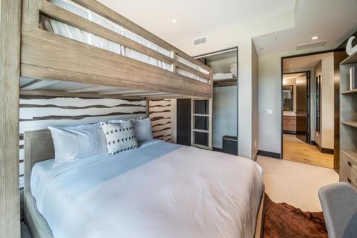 a bedroom with a large white bed in a room at One Snowmass East 303 by Snowmass Mountain Lodging in Snowmass