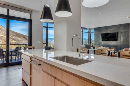 a kitchen with a sink and a counter with a view at One Snowmass West 303 by Snowmass Mountain Lodging in Snowmass