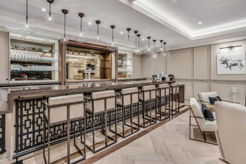 a bar in a restaurant with chairs and tables at One Snowmass West 303 by Snowmass Mountain Lodging in Snowmass