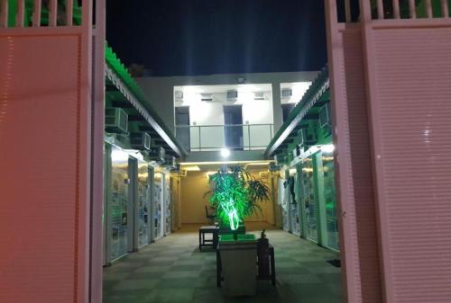 a hallway of a building with a plant in the middle at Pousada Do Futuro in Fortaleza
