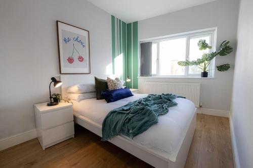 a bedroom with a bed and a window at Charming Chalk Farm Properties in London
