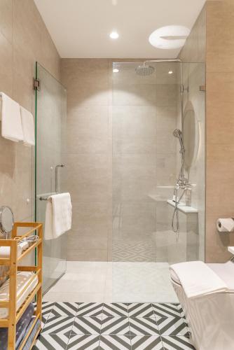 a bathroom with a shower with a glass door at Title Halo Nature Touch 40m2 King Bed Naiyang in Nai Yang Beach